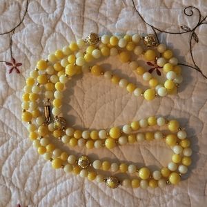 Yellow and gold tone plastic bead necklace